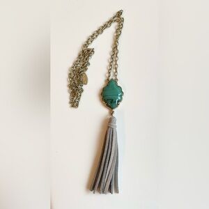 Flirt brand necklace with gold-tone chain, faux stone, & gray suede tassel